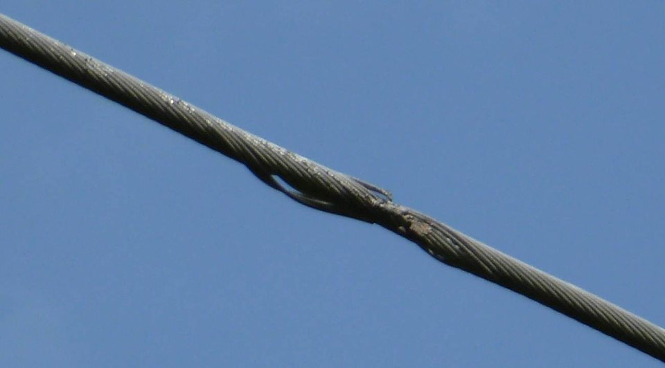 Broken strands from repeated contact.
